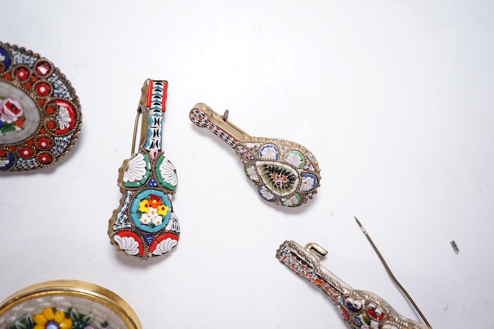 A collection of twenty-eight micro-mosaic brooches, including ten banjo and guitars shaped brooches, six similar large oval brooches, nine small brooches and three long brooches. (28) Condition - good